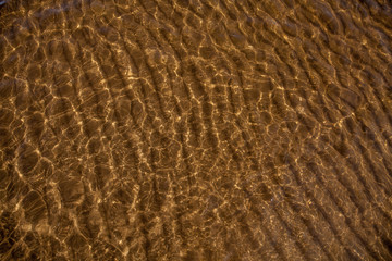 sandy bottom through the transparent water
