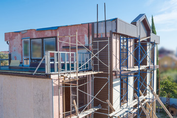 small building under construction, scaffolding