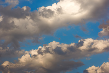 gloomy clouds against the blue sky