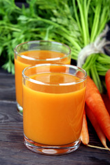 Homemade fresh carrot juice in a transparent glass beaker.