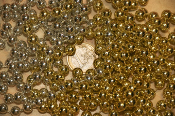 One euro coin in light golden and silver metal glitter beads on marble background abstract vintage...