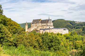 Fototapeta na wymiar Vianden Castle in Luxembourg on a rocky promontory, panoramic view from the main road