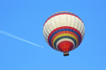 Naklejka premium balloon flying in the sky on the background of a flying plane