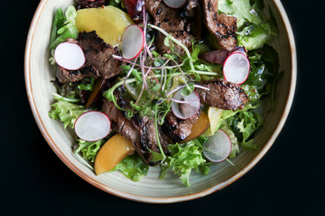 Beef salad with radish, peach and green vegetables