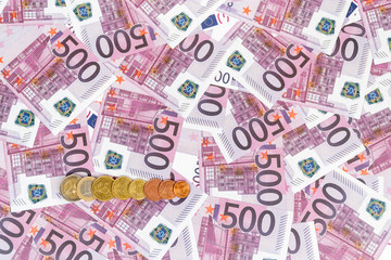 series of euro coins on paper money