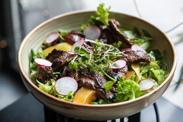 Beef salad with radish, peach and green vegetables