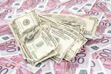 Crumpled dollars on a background of euro