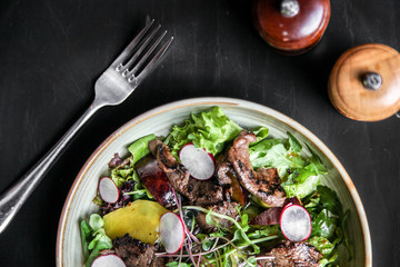 Beef salad with radish, peach and green vegetables