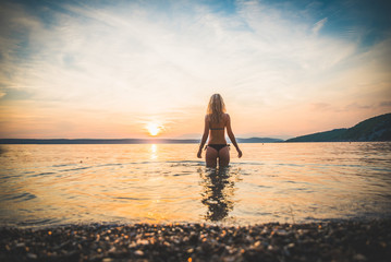 Young attractive girl model silhouette in the water