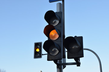 Yellow traffic light for cars, closeup