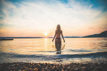 Fototapeta premium Young attractive girl model silhouette in the water
