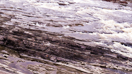 A river bed made of red tuff slices in a Regional Park in the Province of Quebec, Canada.