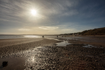 people walking on filey beach in autumn