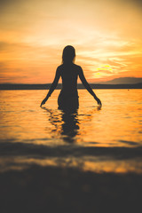 Young attractive girl model silhouette in the water