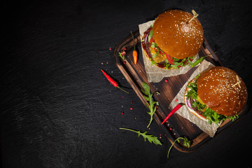 Delicious hamburgers, served on stone.