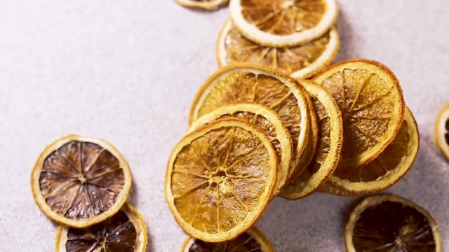 Dried orange rotating on white tecture surface. Close up.