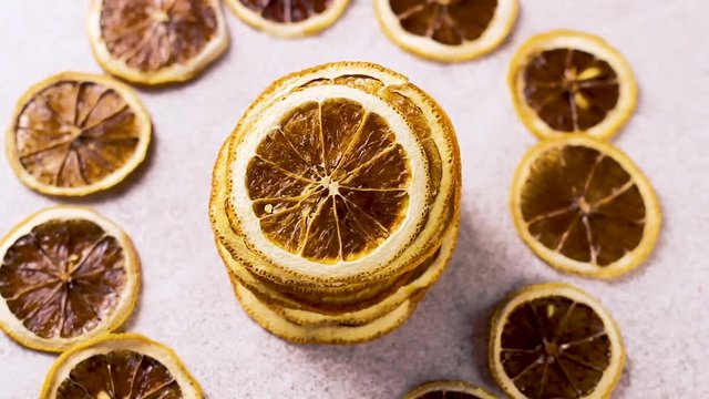 Dried orange rotating on white tecture surface. Close up.