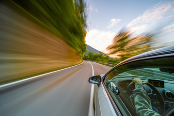 Obraz na płótnie Canvas Car in motion blur driving in the Mountains