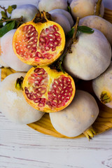 Pomegranate fruit on a wooden plate