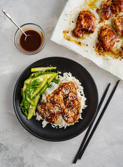 Hoisin Chicken. Traditional Asian cuisine. Chicken with sauce, rice and pickled cucumbers.