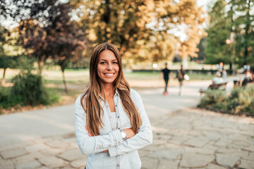 Portrait of attractive young woman in the park.