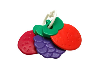Children's toy teether in the form of strawberries, raspberries, blackberries isolated on white background.