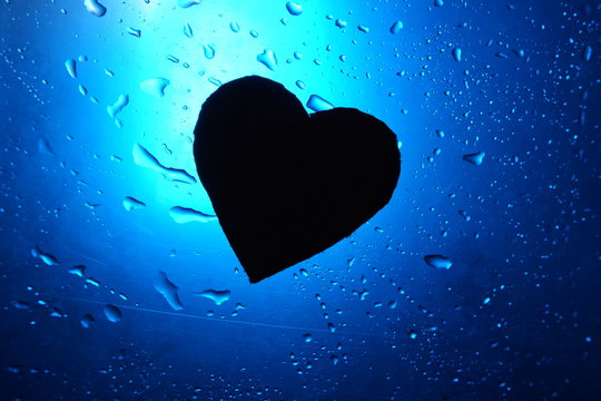 abstract water drop background blue light spot heart silhouette