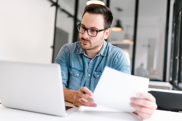 Young man working in modern office. Close-up.
