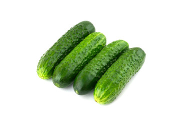 Fresh green cucumbers on a white background. Four cucumbers closeup isolated on white background.