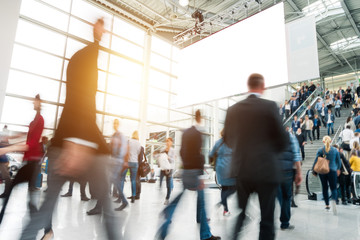 blurred business people at a trade fair