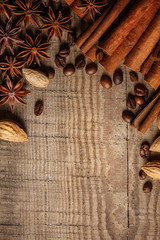 Texture spilling coffee beans, chocolate, cinnamon and cloves. Top view. Copy space.