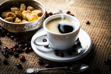 Black coffee in a cup on old background