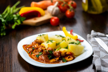 pork goulash served with boiled potatoes