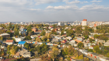 Panoramic view of autumn cityscape against skyline background.