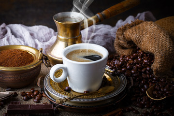 Black coffee in a composition with kitchen accessories
