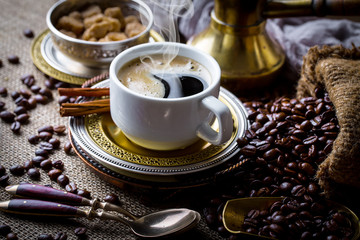 Black coffee in a cup on old background