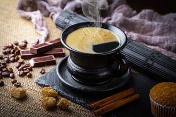 Black coffee in a cup on old background