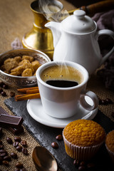 Black coffee in a cup on old background
