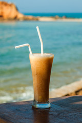 tropical fresh Fruit juice on the background of the sea vertical