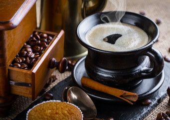 Black coffee in a cup on old background