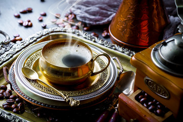 Black coffee in a cup on old background