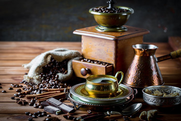 Black coffee in a cup on old background