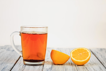 tea and lemon halves on wooden table