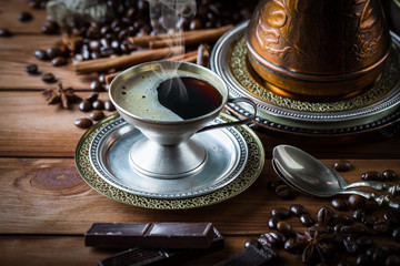 Black coffee in a cup on old background