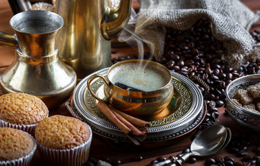 Black coffee in a cup on old background