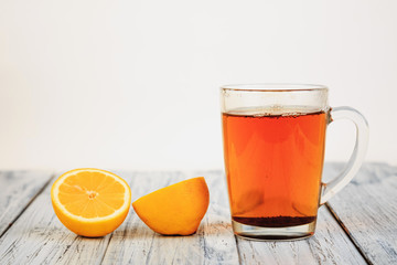  tea and lemon halves on wooden table