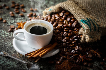 Black coffee in a cup on old background