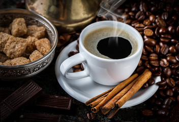 Black coffee in a cup on old background