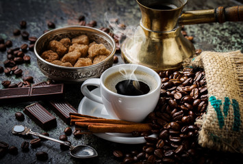 Black coffee in a cup on old background