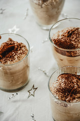 Homemade chocolate mousse portioned in small glasses. Festive dessert, Christmas dinner.